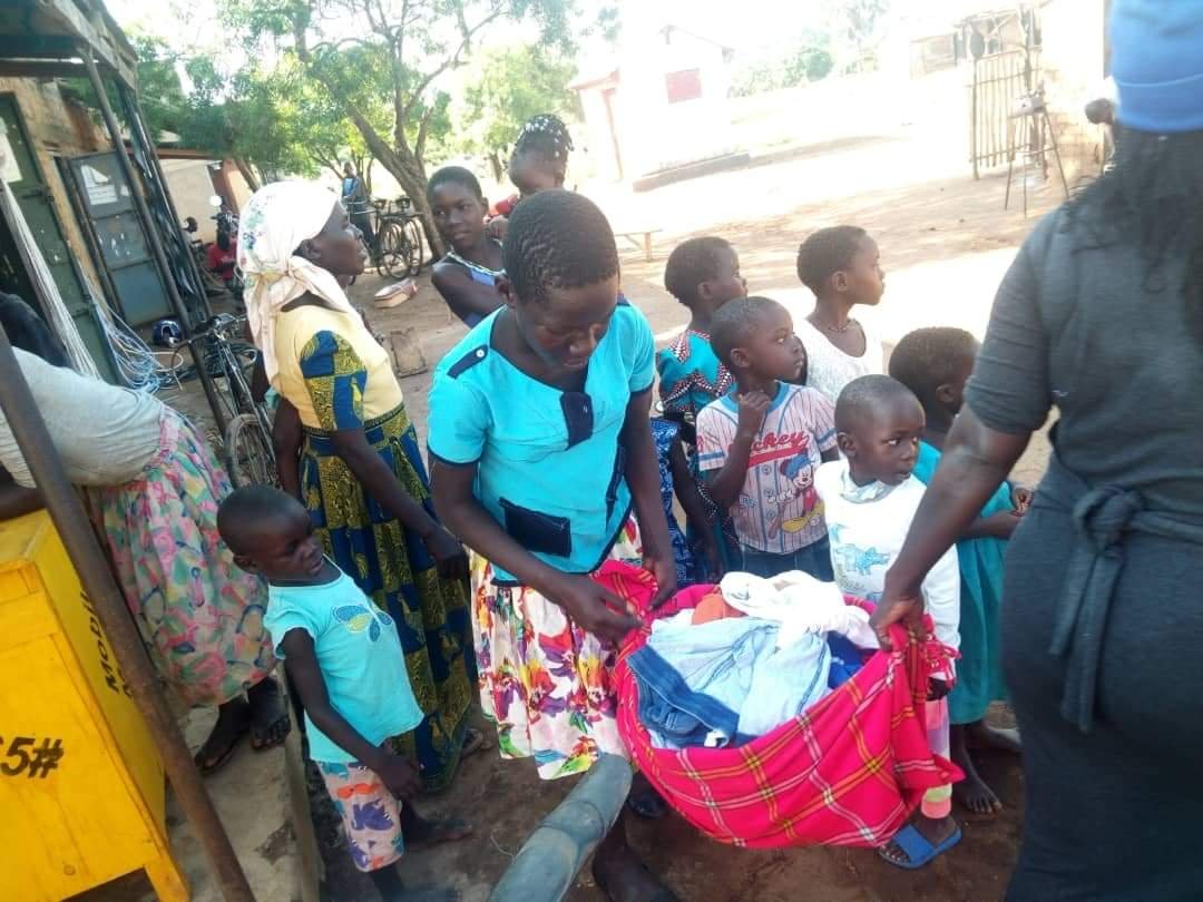 GIVING OUT CLOTHES TO COMMUNITY.